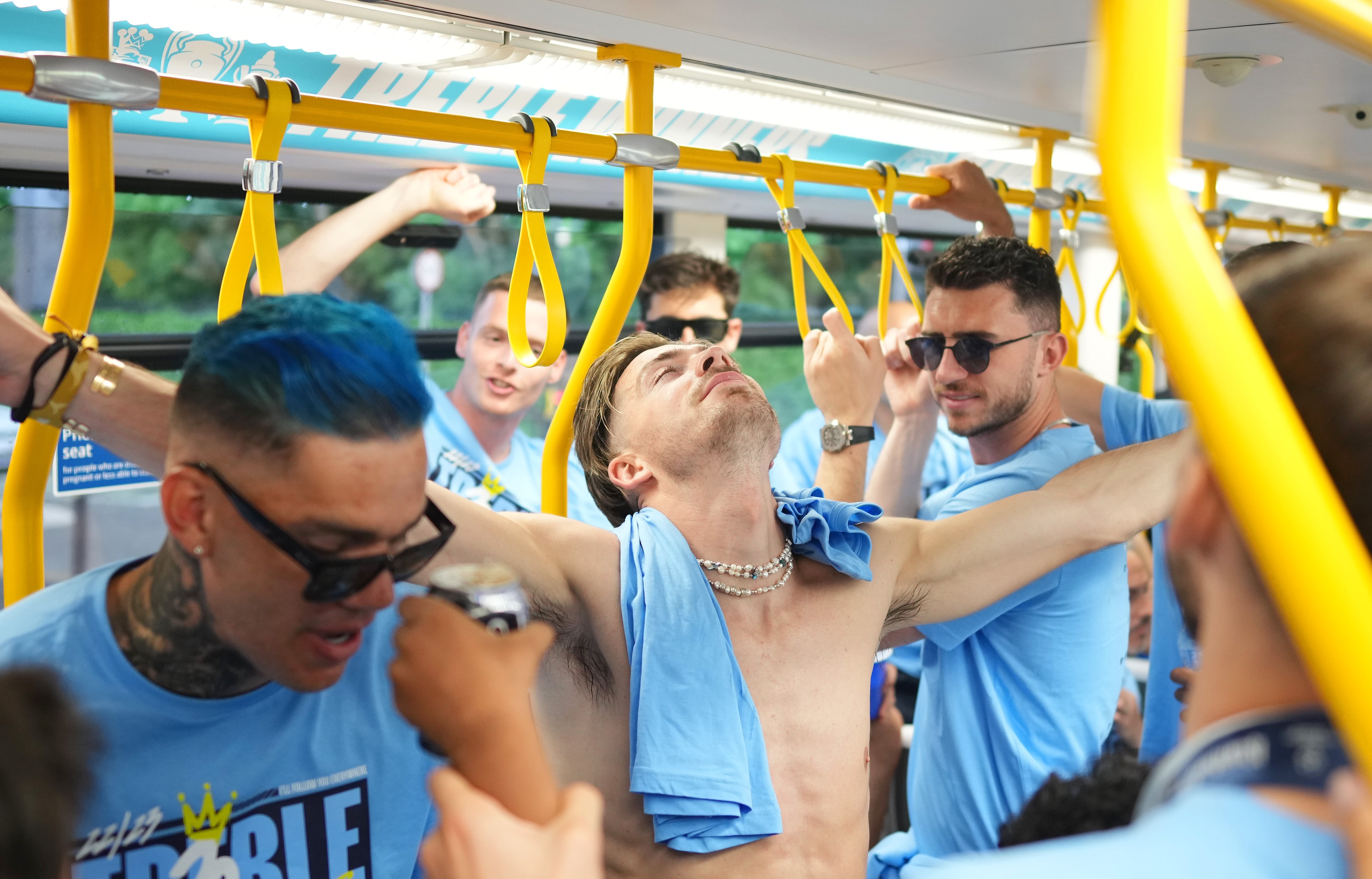 MANCHESTER, ENGLAND - JUNE 12: Jack Grealish of Manchester City reacts as players of Manchester City ride on a Metrolink Tram during the Manchester City trophy parade on June 12, 2023 in Manchester, England. (Photo by Tom Flathers/Manchester City FC via Getty Images)