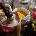 A rice vender fills a container at the Maché Tèt Dlo market in Port-au-Prince, Haiti, Tuesday, July 13, 2021. President Jovenel Moise was assassinated in his home on July 7. (AP Photo/Matias Delacroix)