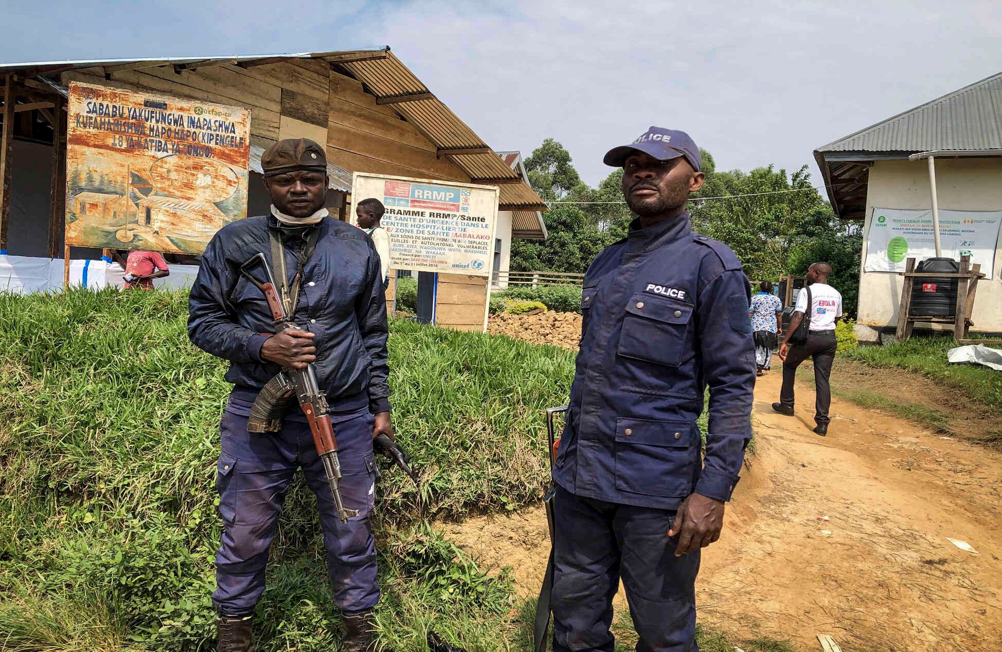 La policía congoleña vigila un centro de salud mientras se realizan vacunaciones contra el ébola en la aldea de Mabalako, en el este del Congo, el lunes 17 de junio de 2019. (AP Photo/Al-hadji Kudra Maliro)