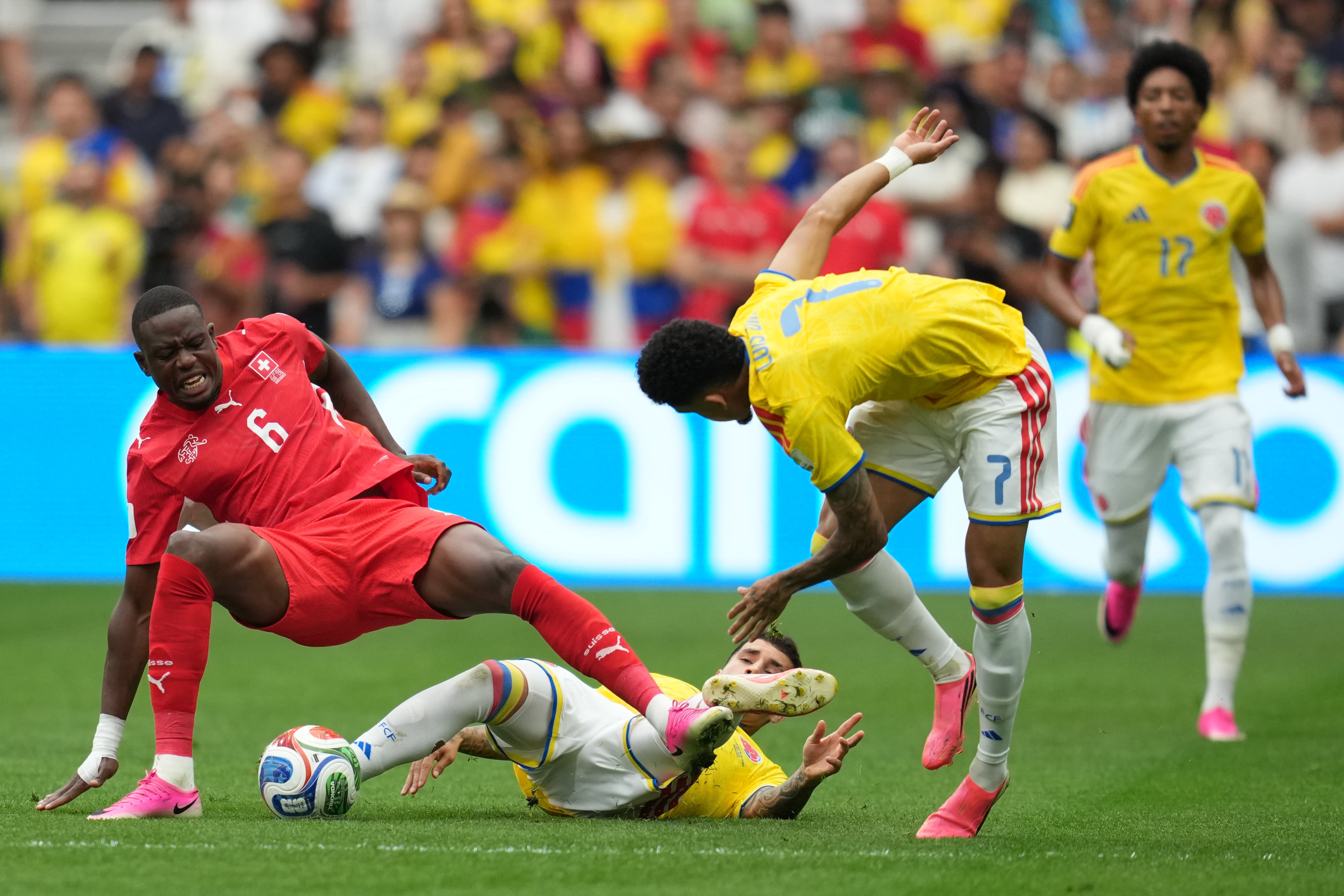 Colombia's Gustavo Puerta (14) tackles Switzerland's Denis Zakaria (6) during the World Cup round of 16 soccer match between Switzerland and Colombia in Vancouver, British Columbia, Tuesday, July 7, 2026. (AP Photo/Abbie Parr)
