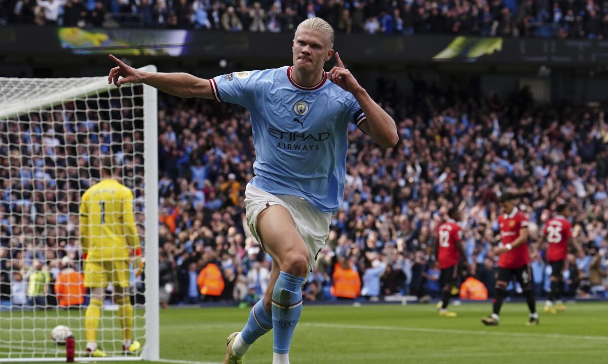 Manchester City's Erling Haaland celebrates after scoring his side's third goal during the English Premier League soccer match between Manchester City and Manchester United at Etihad stadium in Manchester, England, Sunday, Oct. 2, 2022. (AP/Martin Rickett/PA)