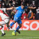 Rayo Vallecano's Spanish midfielder Mario Suarez (L) fights for the ball with Atletico Madrid's Uruguayan forward Luis Suarez during the Spanish League football match between Rayo Vallecano de Madrid and Club Atletico de Madrid at the Vallecas stadium in Madrid on March 19, 2022. (Photo by OSCAR DEL POZO / AFP)
