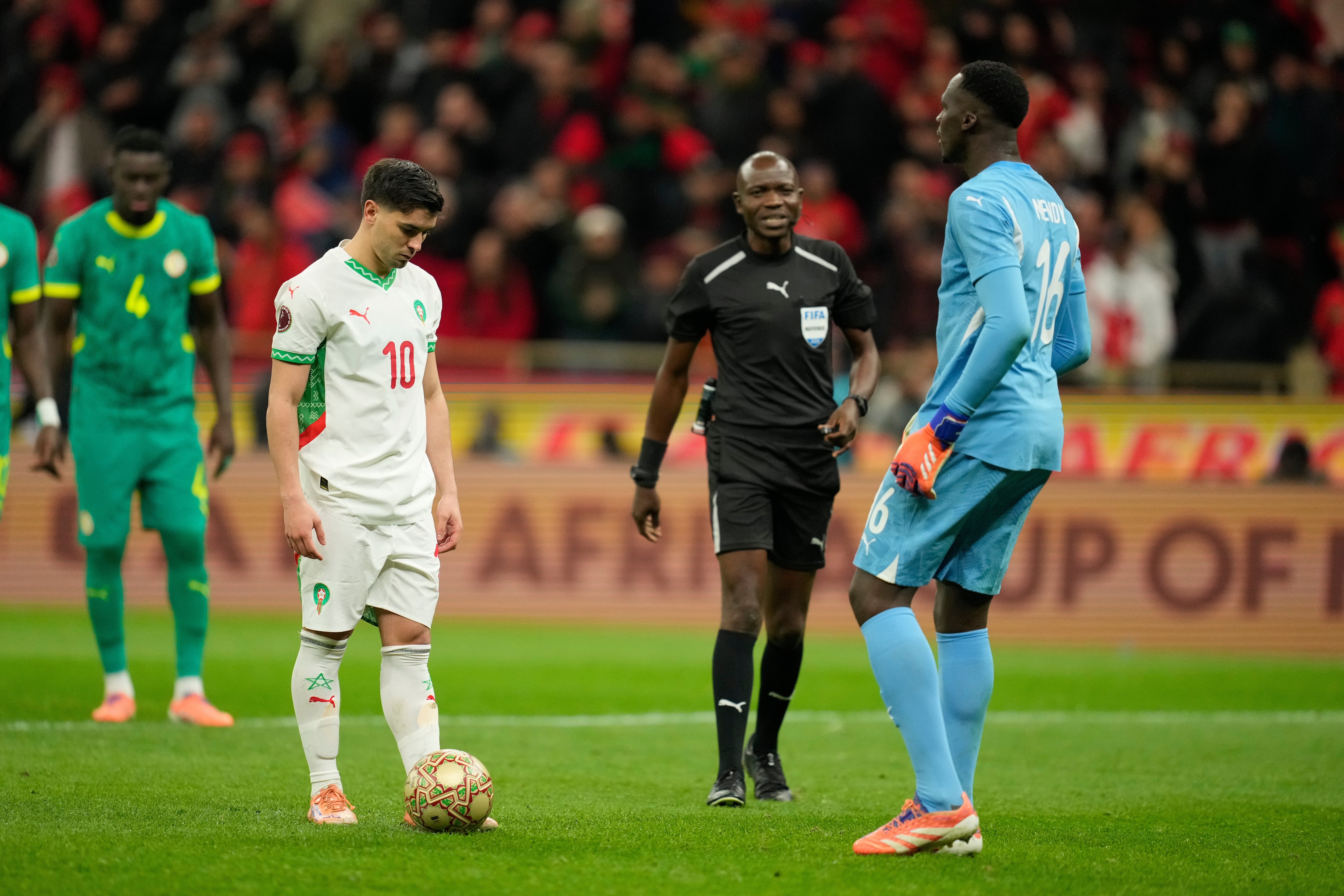 Senegal’s goalkeeper Edouard Osoque Mendy, right, approaches Morocco’s Brahim Abdelkader Díaz before he took a penalty during the Africa Cup of Nations final soccer match between Senegal and Morocco in Rabat, Morocco, Sunday, Jan. 18, 2026. (AP Photo/Mosa'ab Elshamy)
