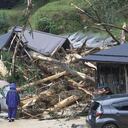 Gente ante los restos de un alud de lodo tras una tormenta en Ayabe, en la prefectura de Kioto, en el oeste de Japón el martes 15 de agosto de 2023. (Kyodo News via AP)
