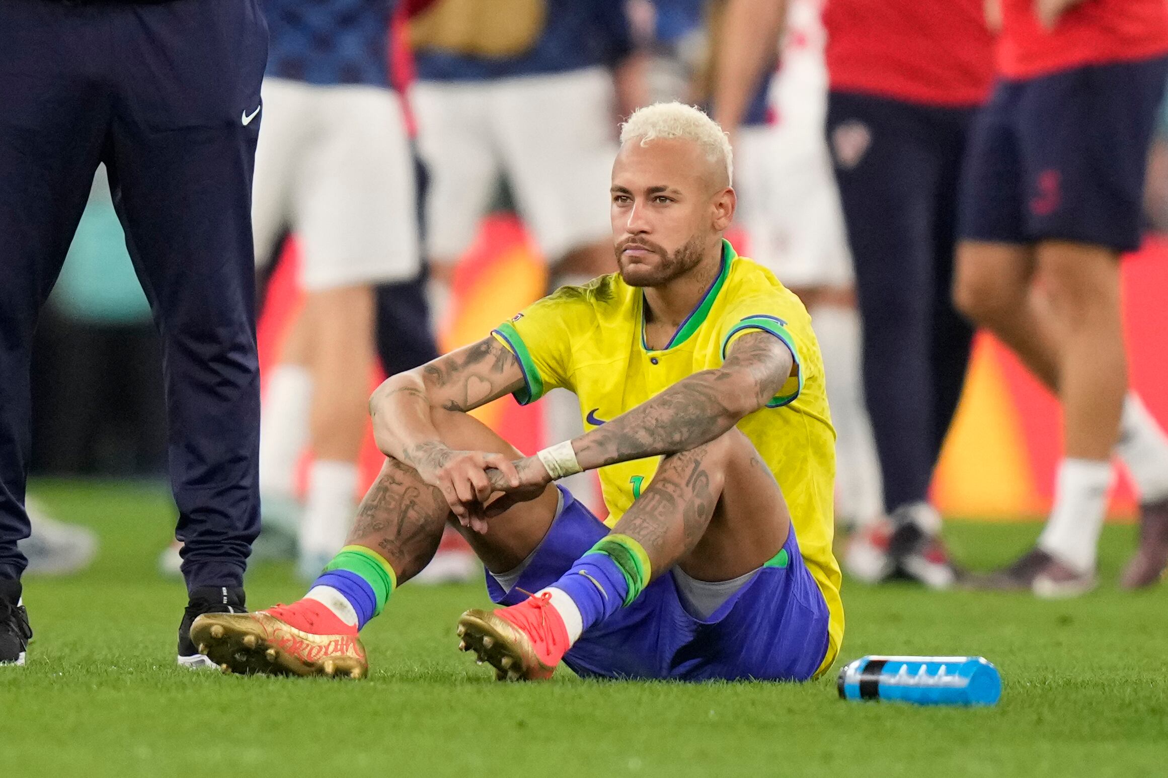 Brazil's Neymar sits on the pitch at the end of the World Cup quarterfinal soccer match between Croatia and Brazil, at the Education City Stadium in Al Rayyan, Qatar, Friday, Dec. 9, 2022. (AP Photo/Darko Bandic)