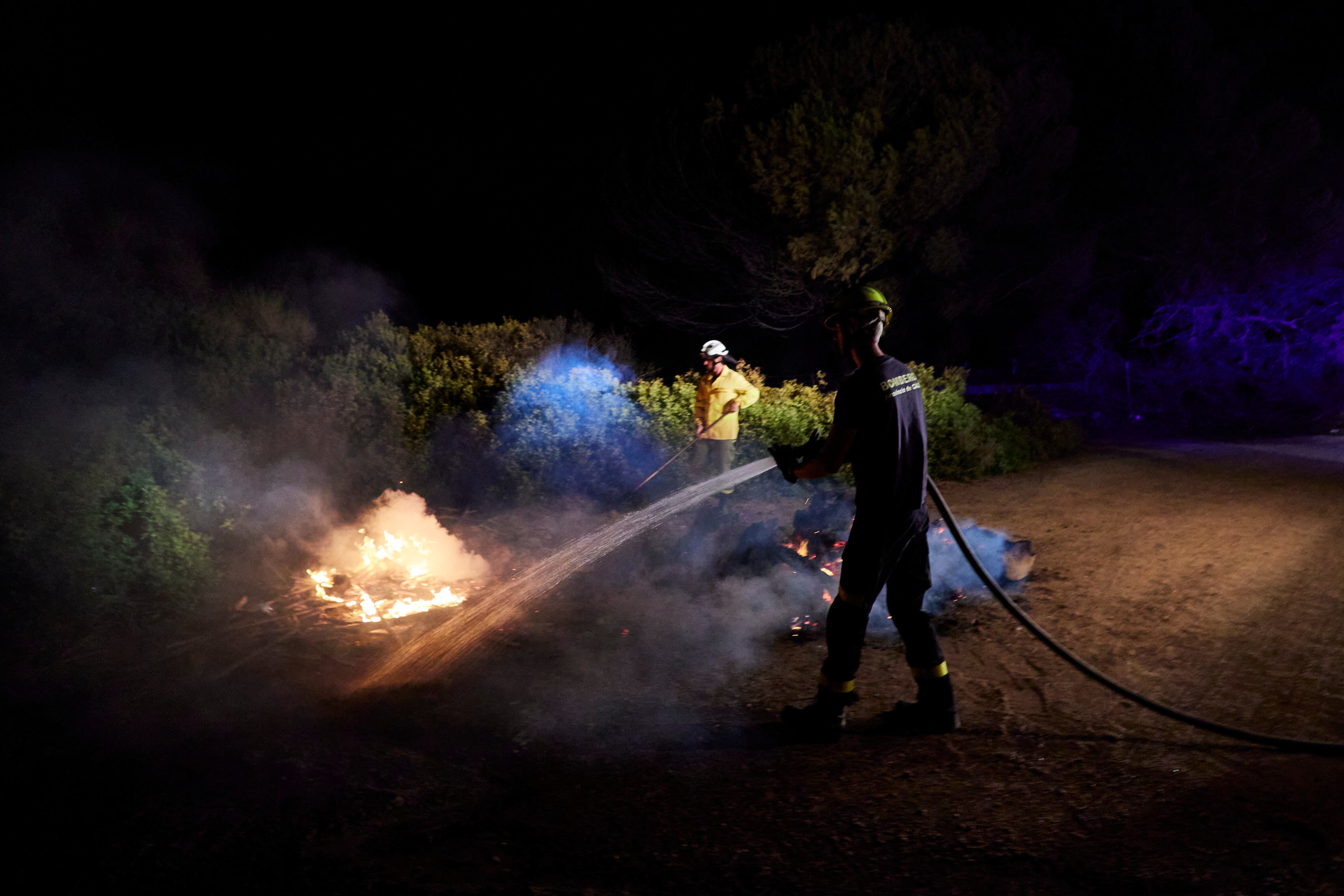 Bomberos apagan un incendio en el interior de Las Canteras, el 6 de agosto de 2023 en Puerto Real (Cádiz, Andalucía). La Junta de Andalucía ha activado este domingo a las 17.15 horas el nivel 1 de alerta por incendio forestal