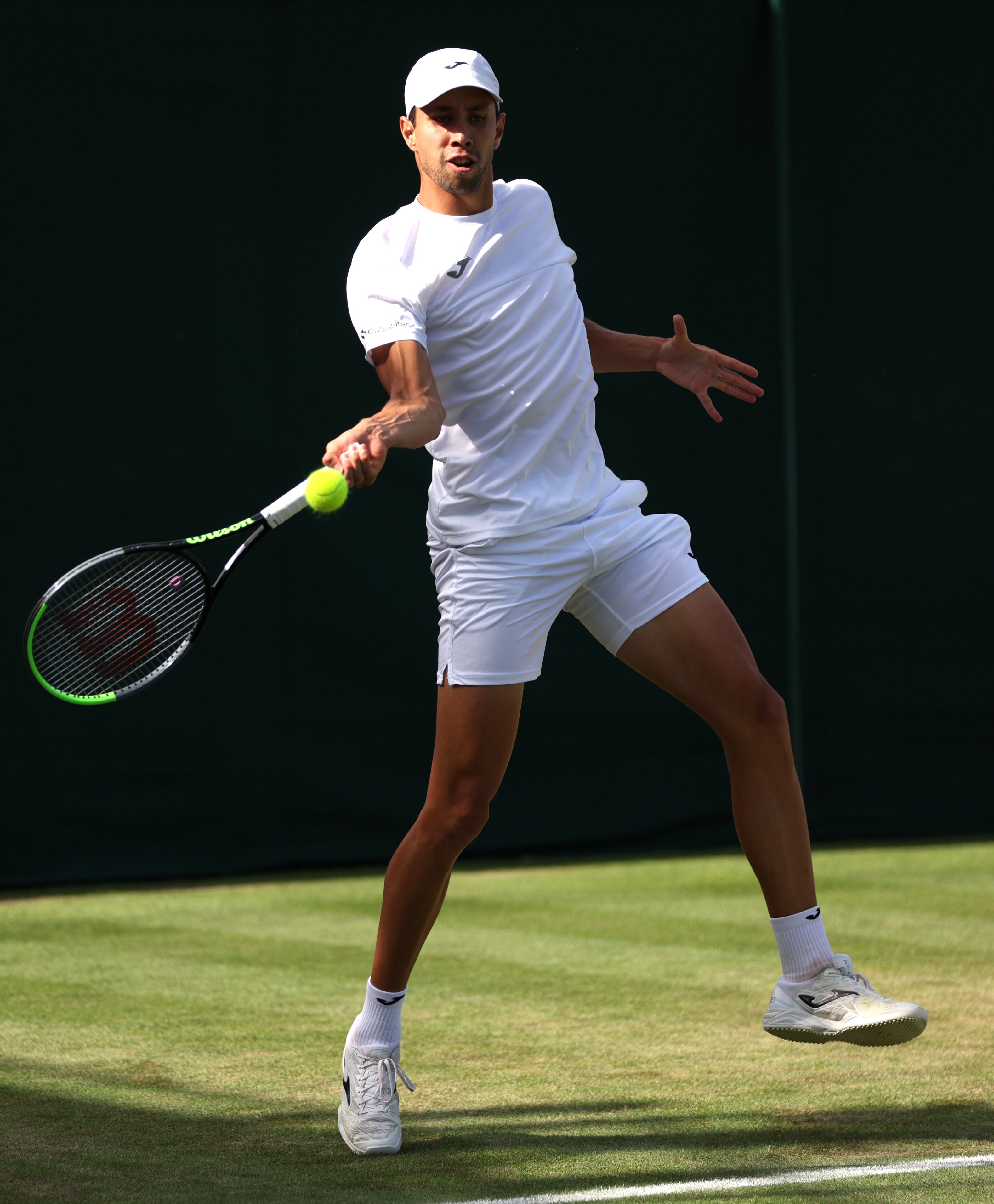 LONDON, ENGLAND - JULY 06: Daniel Elahi Galan of Colombia plays a forehand against Oscar Otte of Germany in the Men's Singles second round match during day four of The Championships Wimbledon 2023 at All England Lawn Tennis and Croquet Club on July 06, 2023 in London, England. (Photo by Clive Brunskill/Getty Images)