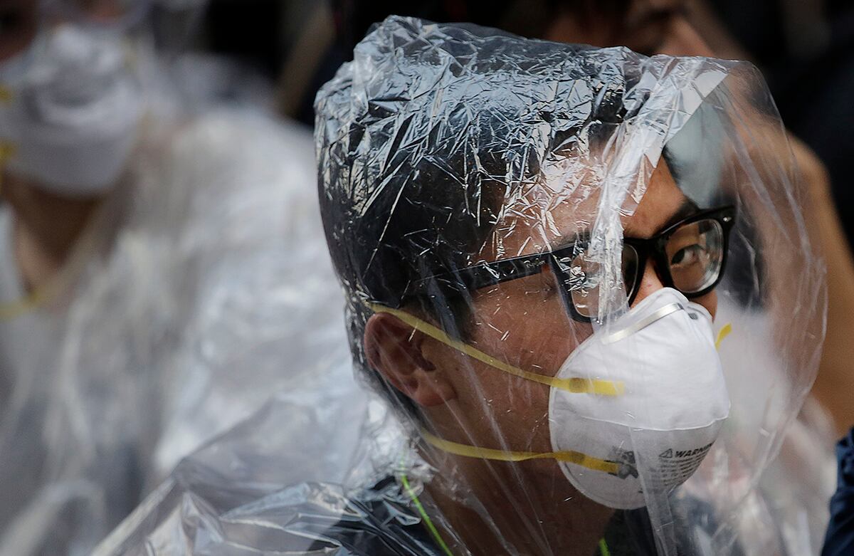 Un estudiante que protesta a favor de la democracia cubre su cara con plástico para protegerse del gas pimienta, en caso de que llegar a ser usado en los enfrentamientos con las autoridades locales, en Hong Kong. (AP)