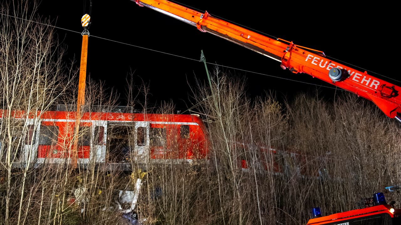 Emergency services at the scene after a train crash in Schaeftlarn, Germany, Monday, Feb. 14, 2022. German police say several people have been injured and at least one person has died in a collision between two commuter trains near Munich. Munich police said the incident happened shortly before 5 p.m. (1600GMT) at Ebenhausen-Schaeftlarn station, about 10 kilometers (6 miles) south of the Bavarian capital. (Lennart Preiss/dpa via AP)