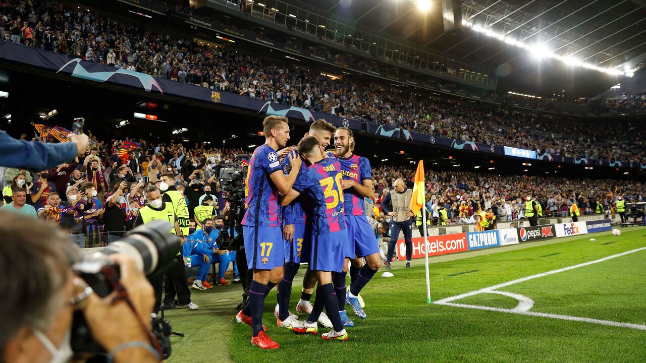 Barcelona's Gerard Pique, second from right, celebrates with his teammates after scoring his side's first goal during a Champions League group E soccer match between F.C. Barcelona and Dinamo Kyiv at Camp Nou stadium in Barcelona, Spain, Wednesday, Oct. 20, 2021. (AP Photo/Joan Monfort)