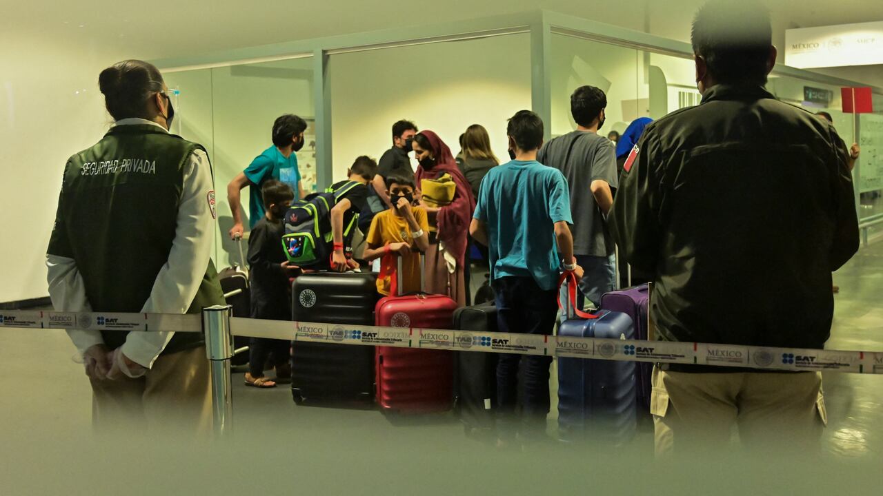 Afghan families that decided to leave Afghanistan after the Taliban seized power arrive at the Benito Juarez international airport in Mexico City on August 25, 2021, after requesting a humanitarian, refugee or asylum visa from the Mexican government. (Photo by PEDRO PARDO / AFP)