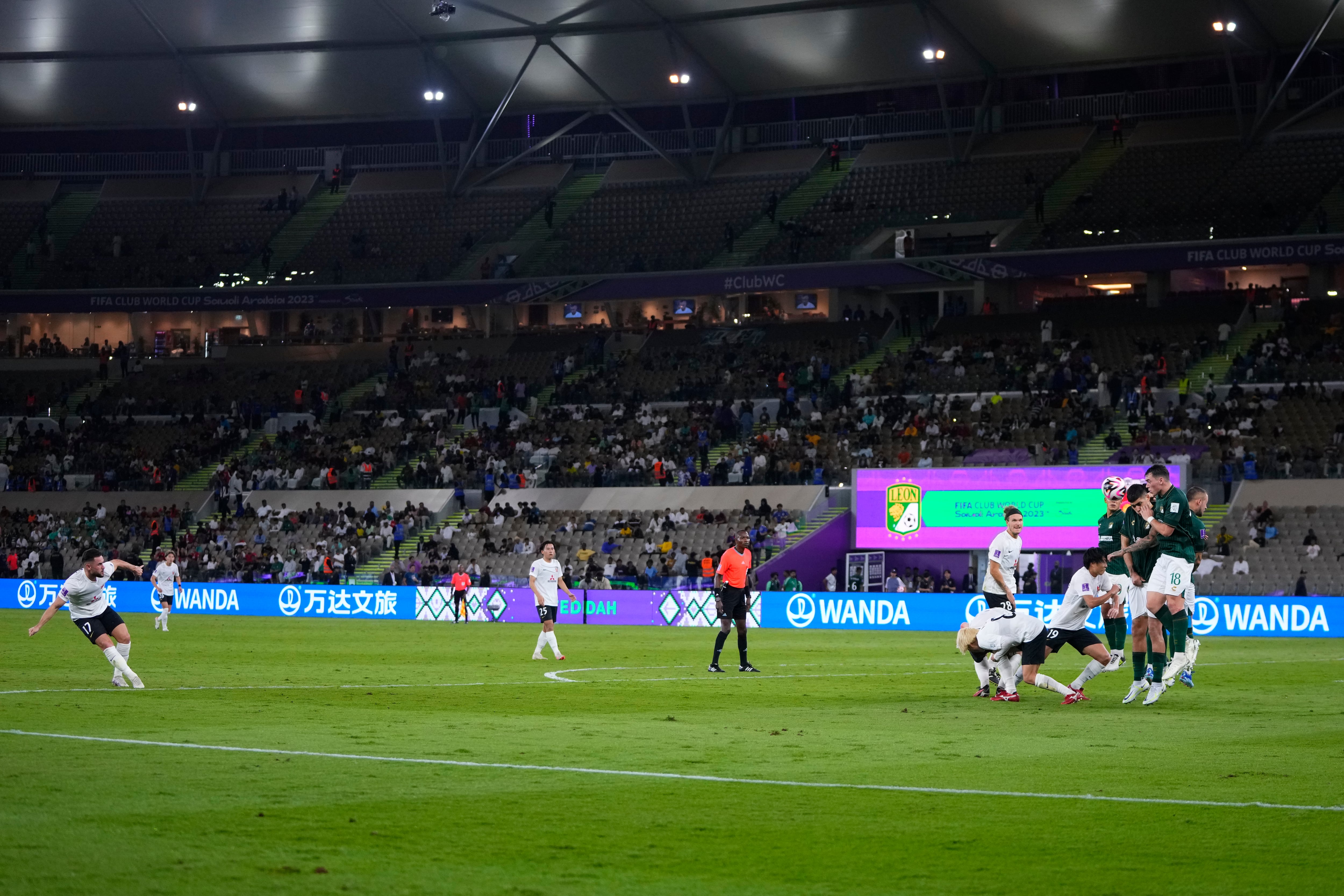 Leon's players, right, block a free kick by Urawa Reds' Alex Schalk during the Soccer Club World Cup second round soccer match between Club Leon and Urawa Reds at Prince Abdullah Al-Faisal Stadium in Jeddah, Saudi Arabia, Friday, Dec. 15, 2023. (AP Photo/Manu Fernandez)