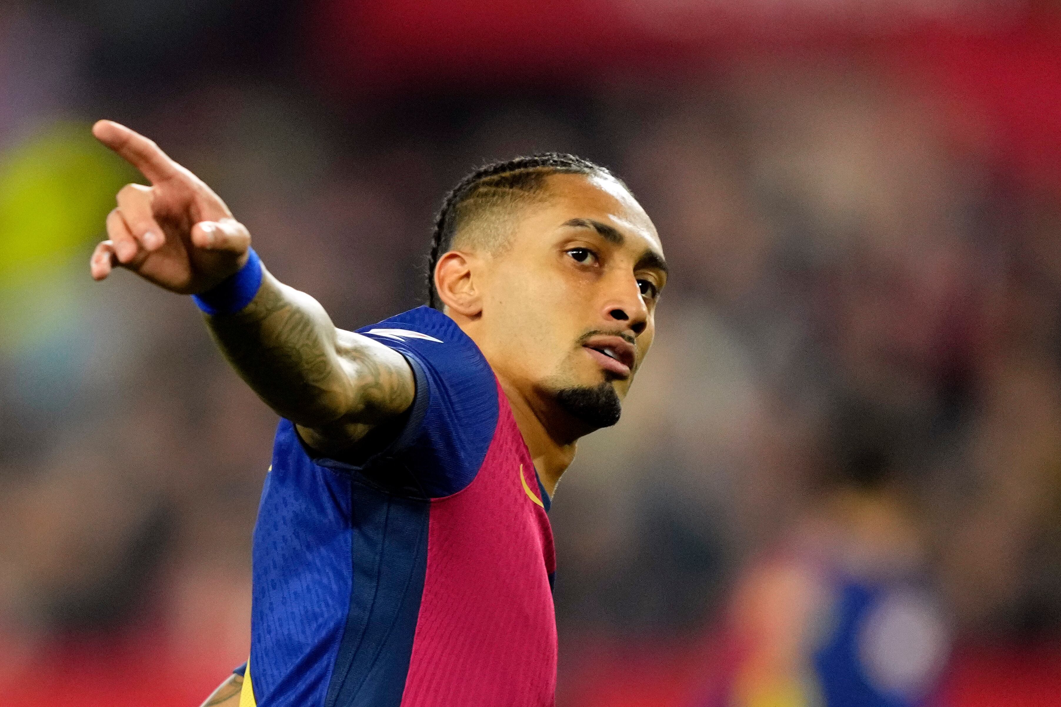 Barcelona's Raphinha celebrates after scoring his side's third goal during a Spanish La Liga soccer match between Sevilla and FC Barcelona at the Ramon Sanchez Pizjuan stadium in Seville, Spain, Sunday, Feb. 9, 2025. (AP Photo/Jose Breton)