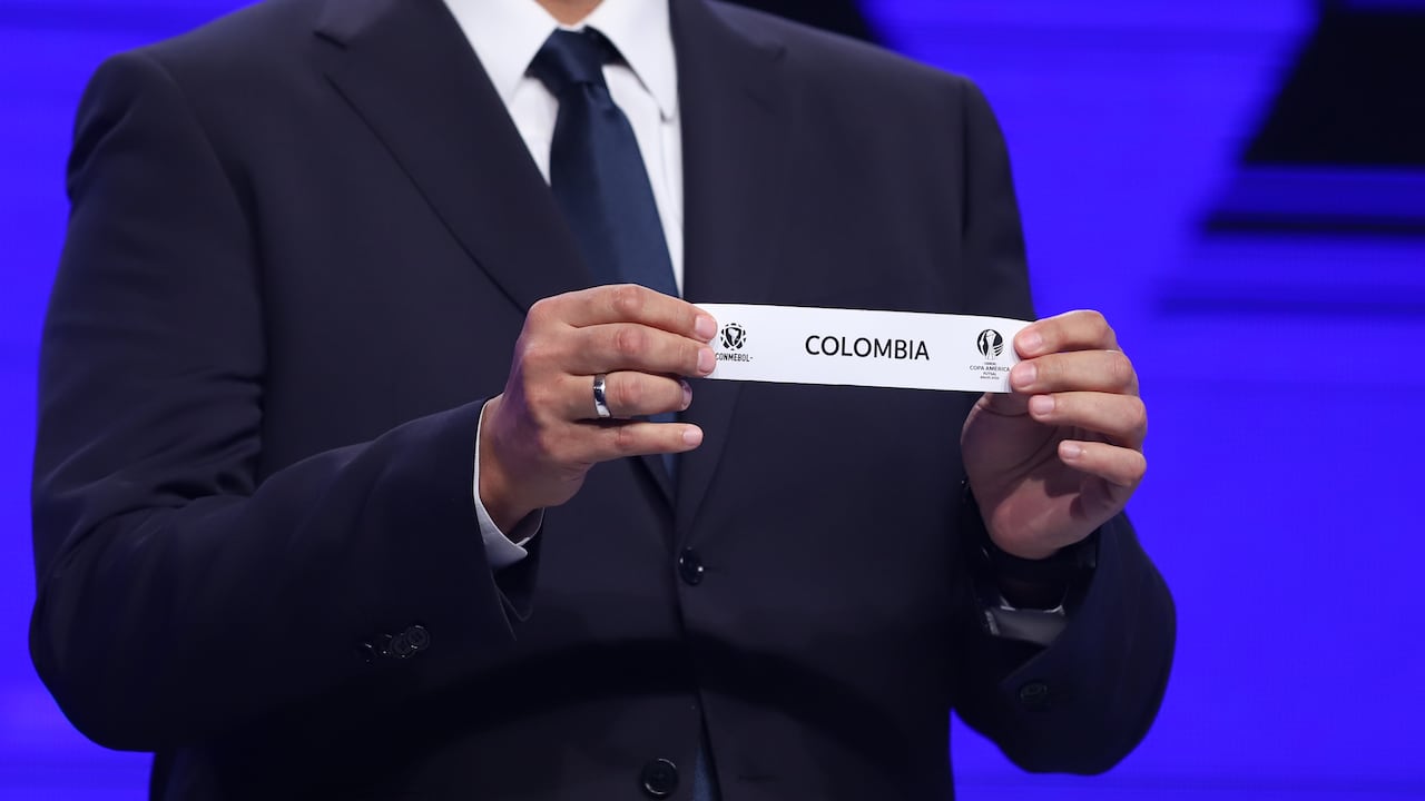 ASUNCION, PARAGUAY - DECEMBER 20: Fred Nantes Director of Clubs Competitions draws out the card of Colombia during the Copa America Futsal 2022 draw on December 20, 2021 in Asuncion, Paraguay. (Photo by Nathalia Aguilar - Pool/Getty Images)