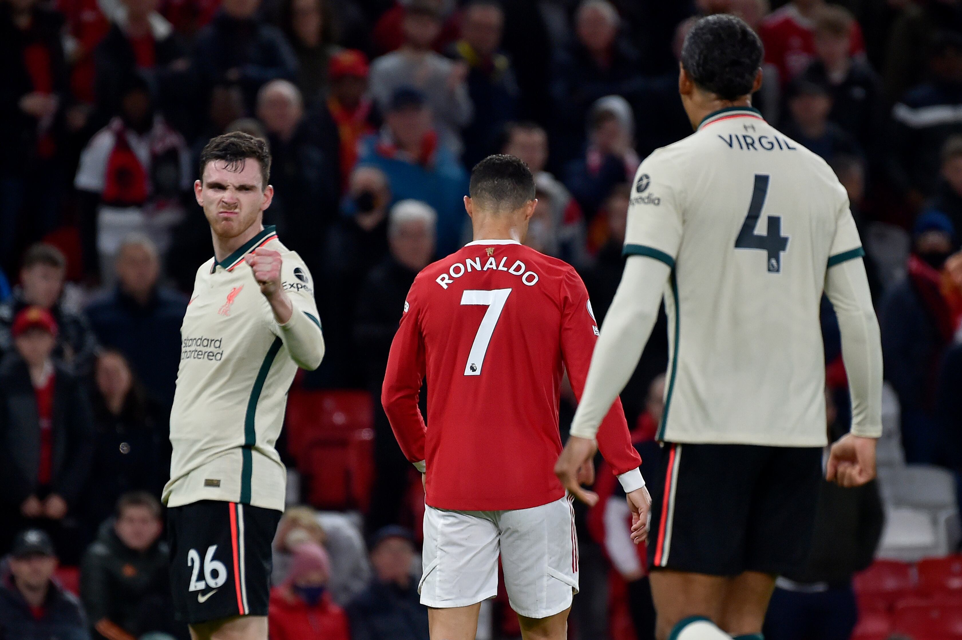 Liverpool's Andrew Robertson, left, gestures next to Manchester United's Cristiano Ronaldo at the end of the English Premier League soccer match between Manchester United and Liverpool at Old Trafford in Manchester, England, Sunday, Oct. 24, 2021. Liverpool won 5-0. (AP Photo/Rui Vieira)