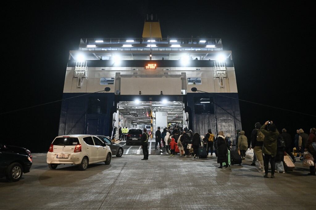 La gente se embarca en un ferry cuando salen tras los recurrentes terremotos, en la isla griega de Santorini, el 4 de febrero de 2025. Nuevos temblores nocturnos sacudieron la principal isla turística de Grecia, Santorini, según informes de los medios, lo que llevó a la gente a dormir al aire libre y a otros a partir en avión o ferry. (Foto de -STR/AFP)
