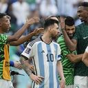 Argentina's Lionel Messi standing beside Saudi Arabia's players celebrating after winning the World Cup group C soccer match between Argentina and Saudi Arabia at the Lusail Stadium in Lusail, Qatar, Tuesday, Nov. 22, 2022. (AP Photo/Natacha Pisarenko)