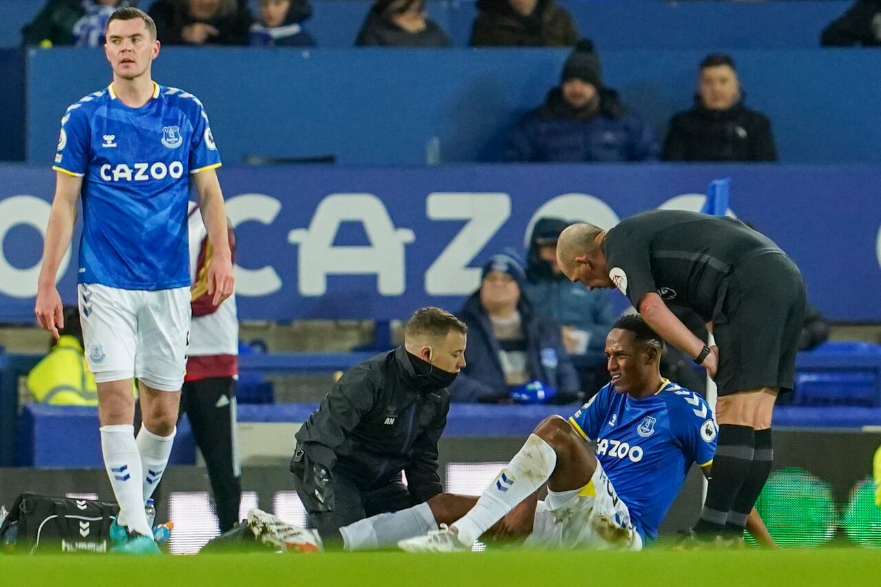 Everton's Yerry Mina receives treatment during the Premier League soccer match between Everton and Arsenal at Goodison Park in Liverpool, England, Monday Dec. 6. 2021, 2021. (AP Photo/Jon Super)