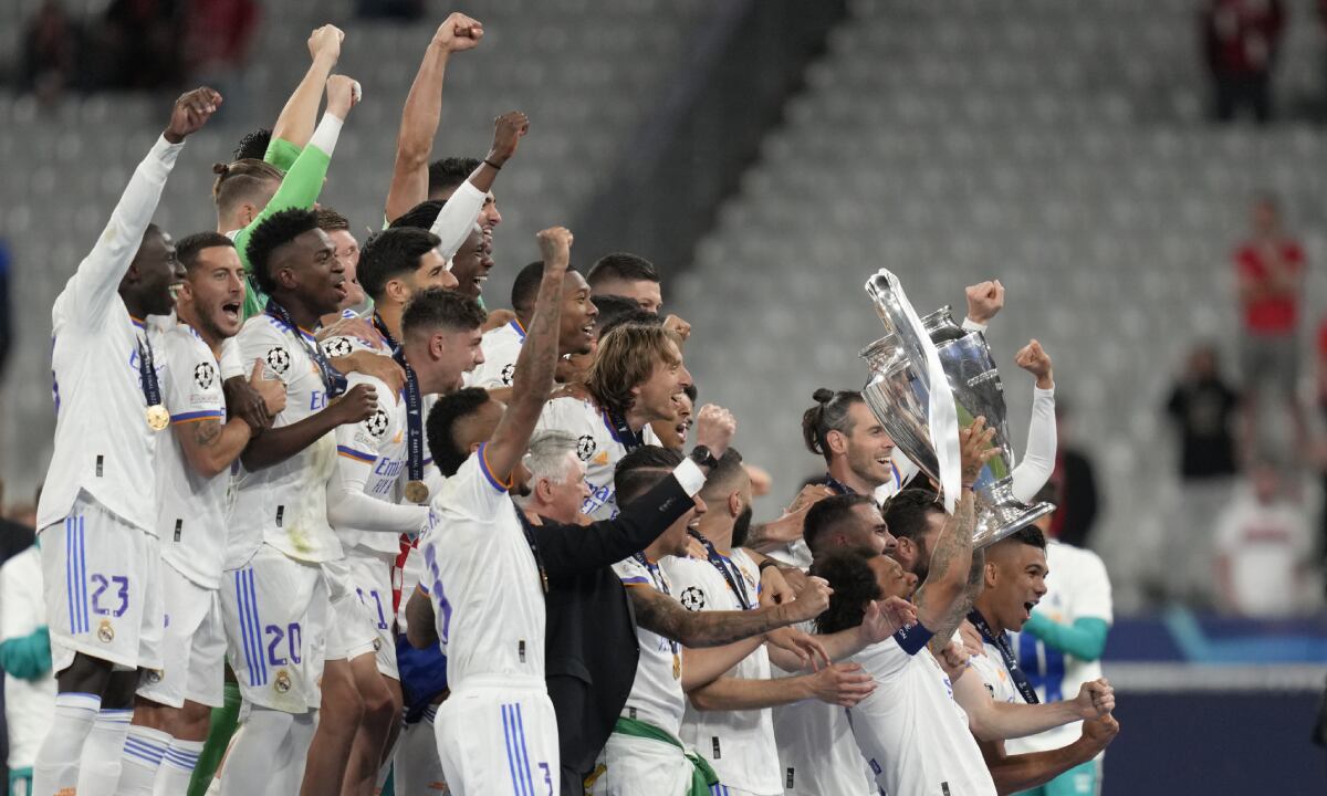 Real Madrid's Marcelo, center right, lifts the trophy after winning the Champions League final soccer match between Liverpool and Real Madrid at the Stade de France in Saint Denis near Paris, Saturday, May 28, 2022. Real Madrid defeated Liverpool 1-0. (AP/Kirsty Wigglesworth)
