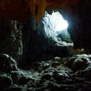 Dau Go cave with spectacular stalagmites and stalactites of various shapes. Daylight entering a hole in the top.