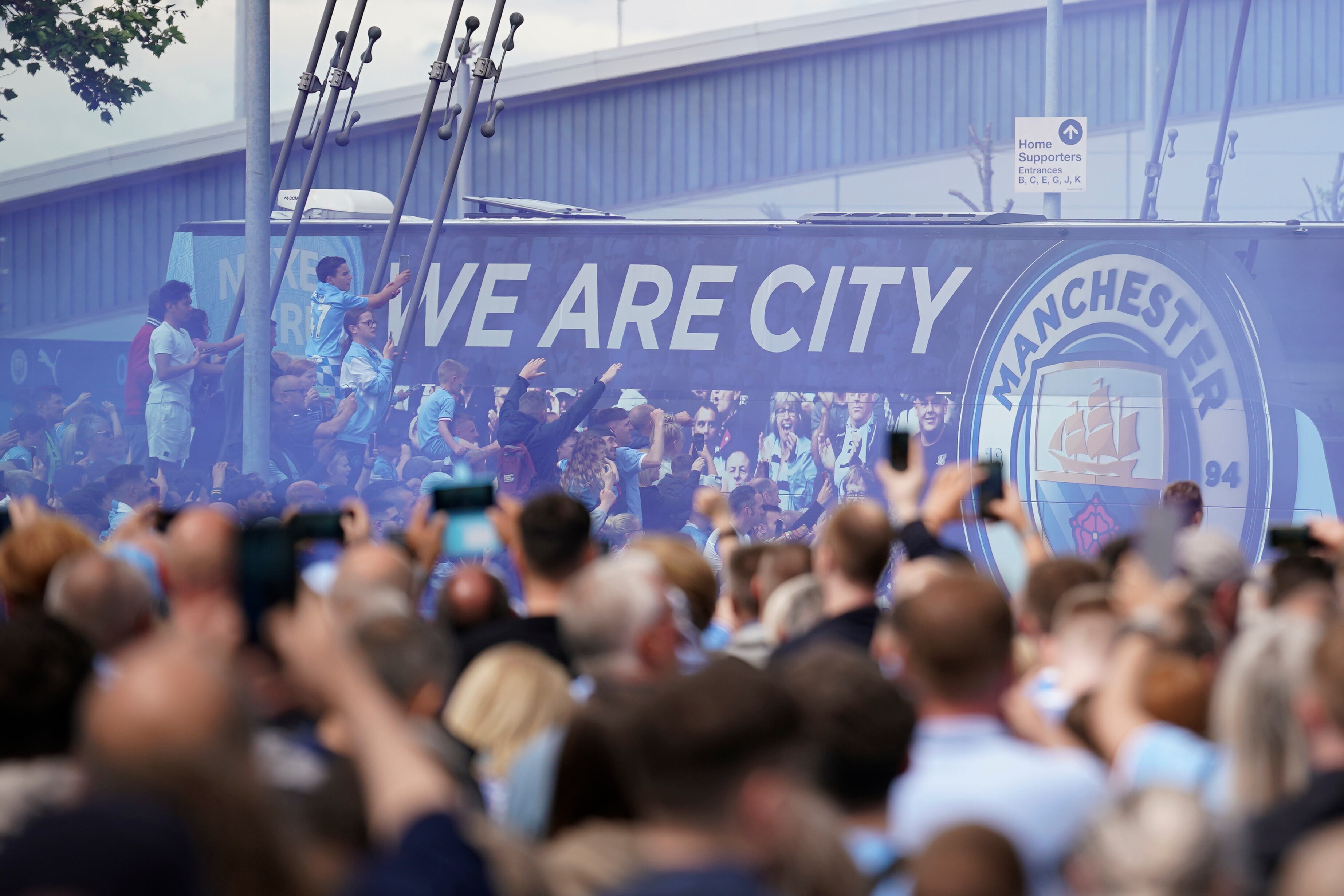 FILE - Fans welcome Manchester City players before the start of the English Premier League soccer match between Manchester City and Aston Villa at the Etihad Stadium in Manchester, England, Sunday, May 22, 2022.  Manchester City has been accused of numerous breaches of the Premier League's financial regulations between 2009-18. The period covers the first nine full seasons under the club’s Abu Dhabi ownership. City won the league on three occasions during that time in 2012, 2014 and 2018. (AP Photo/Dave Thompson, File)