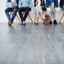 Foto de estudio recortada de un grupo de diversos empresarios esperando en línea desempleo