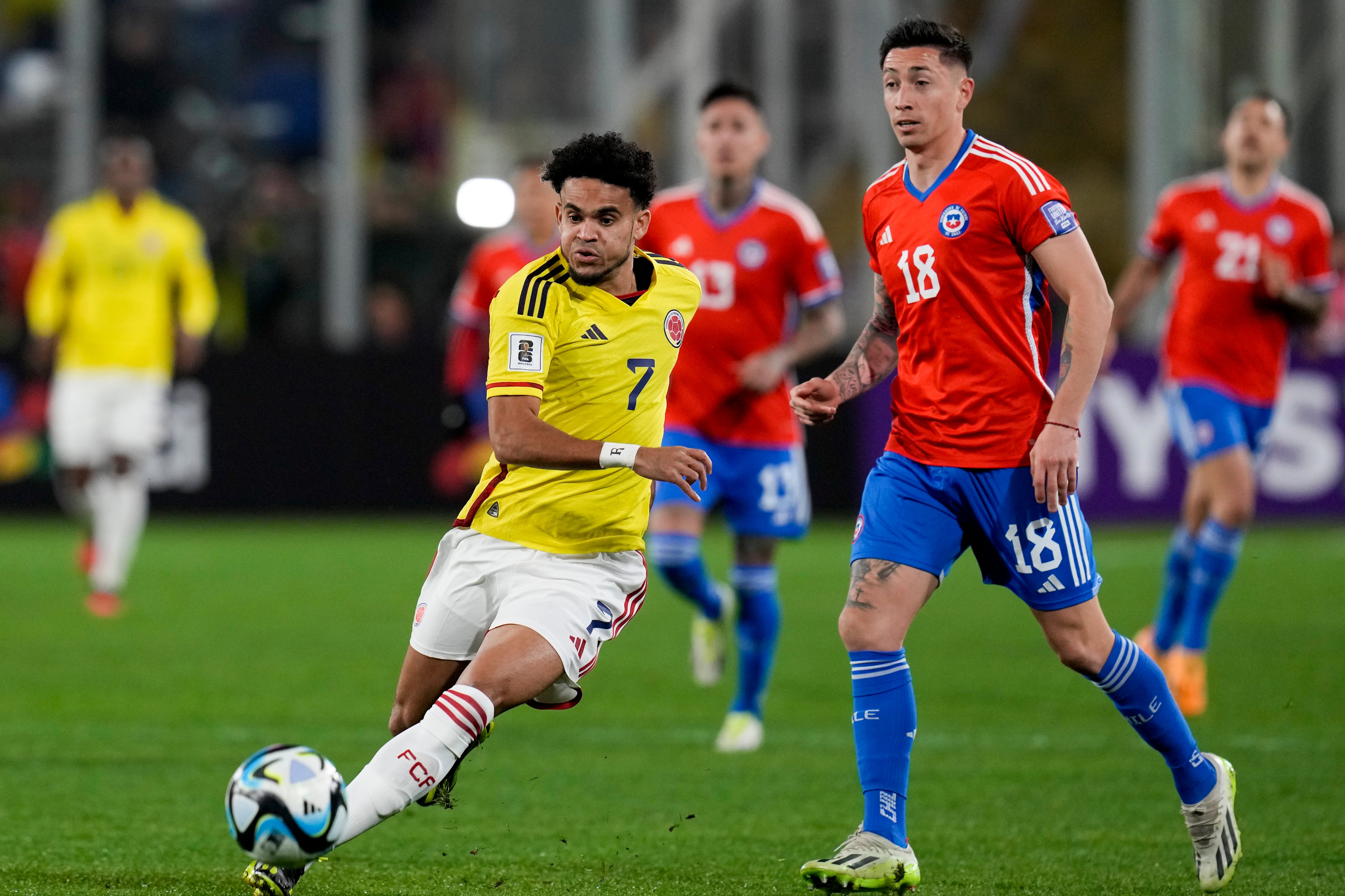 Colombia's Luis Diaz, left, and Chile's Rodrigo Echeverria battle for the ball during a qualifying soccer match for the FIFA World Cup 2026 at Monumental stadium in Santiago, Chile, Tuesday, Sept. 12, 2023. (AP Photo/Esteban Felix)