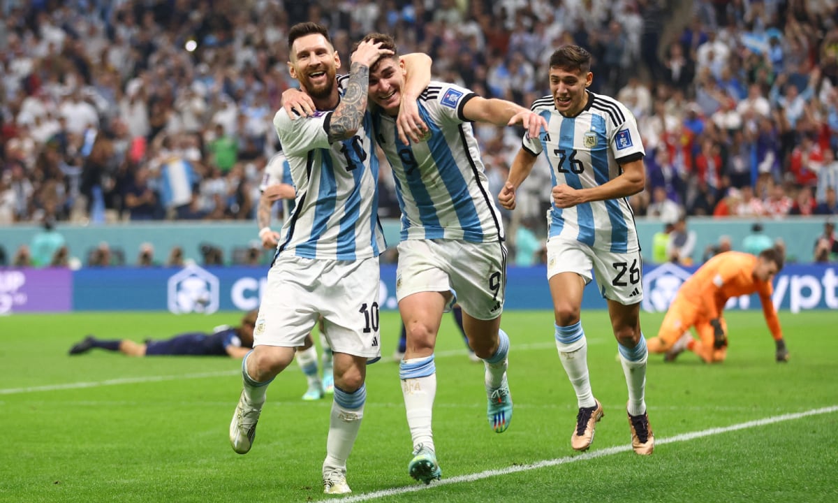 Soccer Football - FIFA World Cup Qatar 2022 - Semi Final - Argentina v Croatia - Lusail Stadium, Lusail, Qatar - December 13, 2022 Argentina's Julian Alvarez celebrates scoring their second goal with Lionel Messi and Nahuel Molina REUTERS/Carl Recine