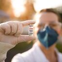 Woman holding covid-19 vaccine.