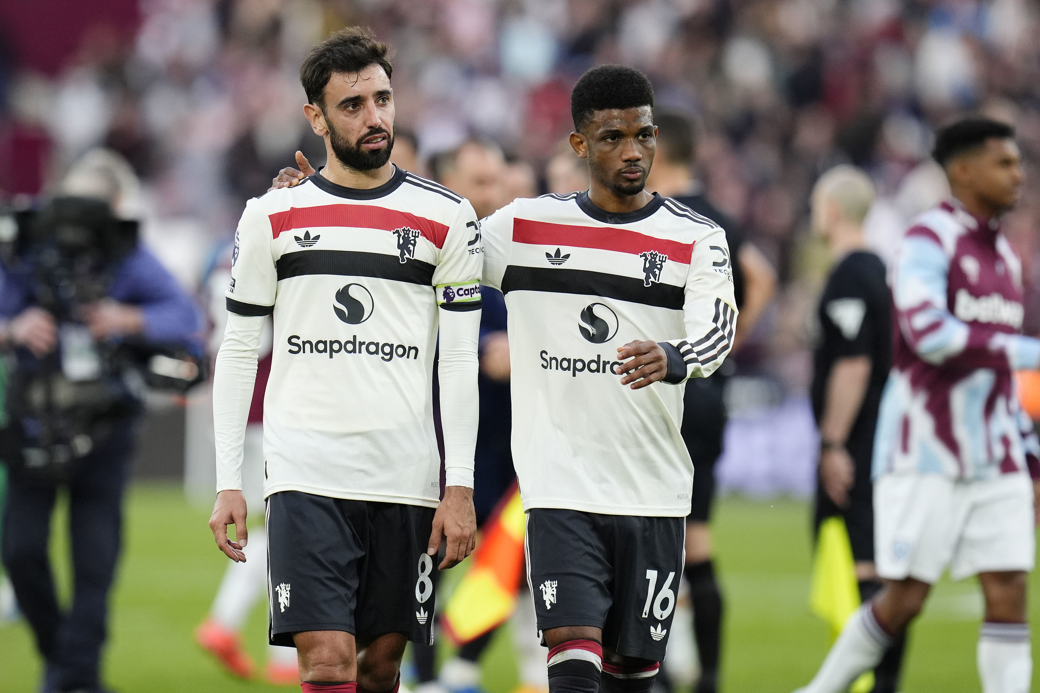Manchester United's Bruno Fernandes (left) and Amad Diallo react after the English Premier League soccer match between West Ham United and Manchester United at the London Stadium in London, Sunday, Oct. 27, 2024. (Nick Potts/PA via AP)