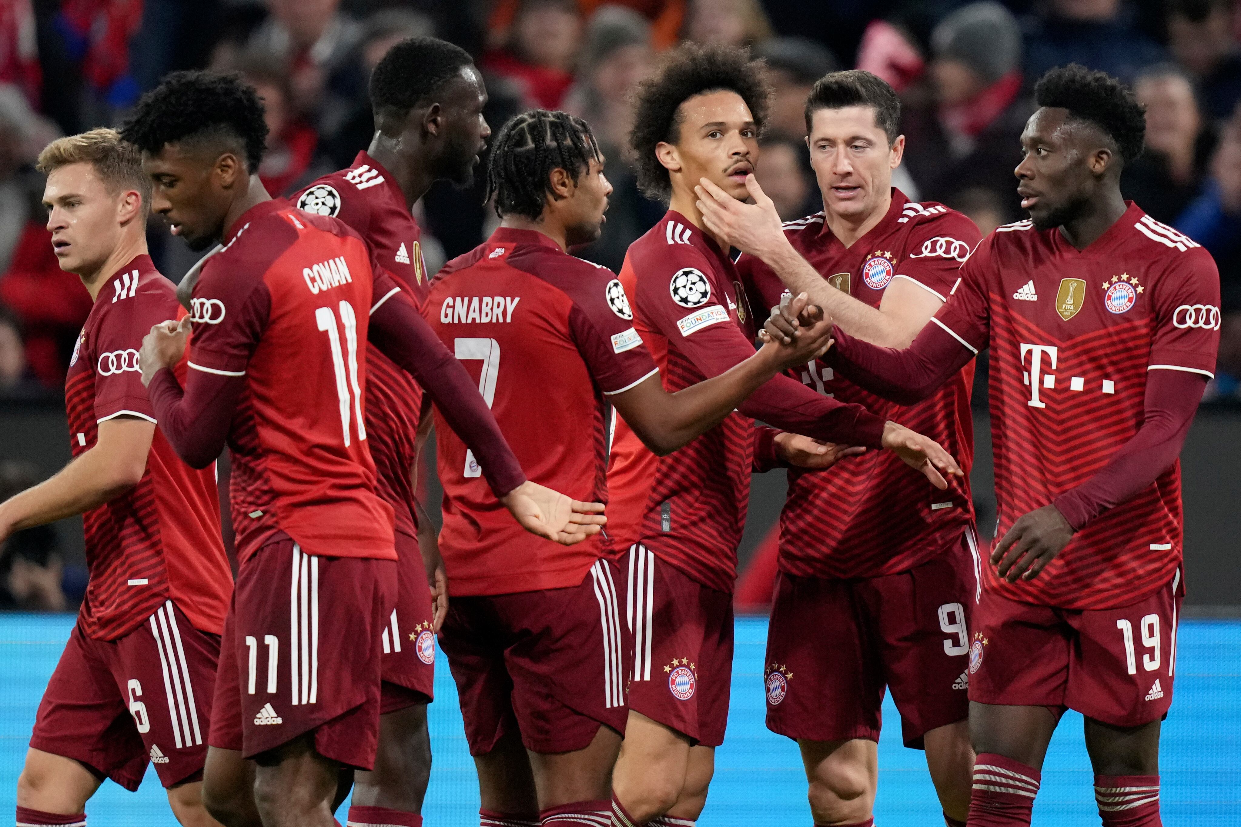 FILE -Bayern's Joshua Kimmich, from left, Kingsley Coman, Tanguy Nianzou, Serge Gnabry, Leroy Sane, Robert Lewandowski and Alphonso Davies celebrate after scoring during the Champions League group E soccer match between Bayern Munich and Benfica Lisbon in Munich, Germany, Tuesday, Nov. 2, 2021.  The German league resumes in a depleted state on Friday, when defending champion Bayern Munich will struggle to field a competitive 11 against Borussia Moenchengladbach. Captain Manuel Neuer, Lucas Hernandez, Kingsley Coman, Corentin Tolisso, Alphonso Davies, Leroy Sane, Dayot Upamecano, Omar Richards and Tanguy Nianzou are on Bayern’s infected list.  (AP Photo/Matthias Schrader,file)