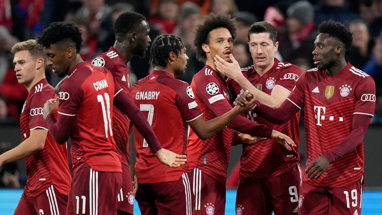 FILE -Bayern's Joshua Kimmich, from left, Kingsley Coman, Tanguy Nianzou, Serge Gnabry, Leroy Sane, Robert Lewandowski and Alphonso Davies celebrate after scoring during the Champions League group E soccer match between Bayern Munich and Benfica Lisbon in Munich, Germany, Tuesday, Nov. 2, 2021. The German league resumes in a depleted state on Friday, when defending champion Bayern Munich will struggle to field a competitive 11 against Borussia Moenchengladbach. Captain Manuel Neuer, Lucas Hernandez, Kingsley Coman, Corentin Tolisso, Alphonso Davies, Leroy Sane, Dayot Upamecano, Omar Richards and Tanguy Nianzou are on Bayern’s infected list. (AP Photo/Matthias Schrader,file)