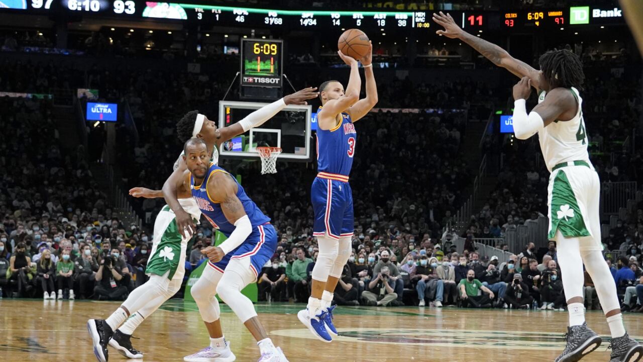 Golden State Warriors guard Stephen Curry (30) shoots a three-point shot off of a screen by teammate Andre Iguodala as Boston Celtics guard Josh Richardson, left, and Celtics center Robert Williams III (44) try to block the shot during the second half of an NBA basketball game, Friday, Dec. 17, 2021, in Boston. (AP/Mary Schwalm)