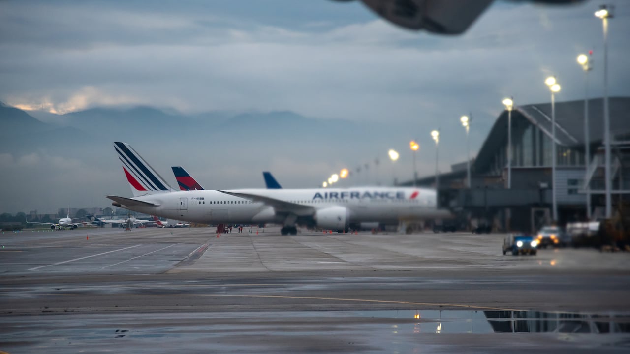 Plane of the airline Air France at the El Dorado airport in the city of Bogotá, seen through the jet of gases from an airplane turbine. Bogota Colombia. November 28, 2020