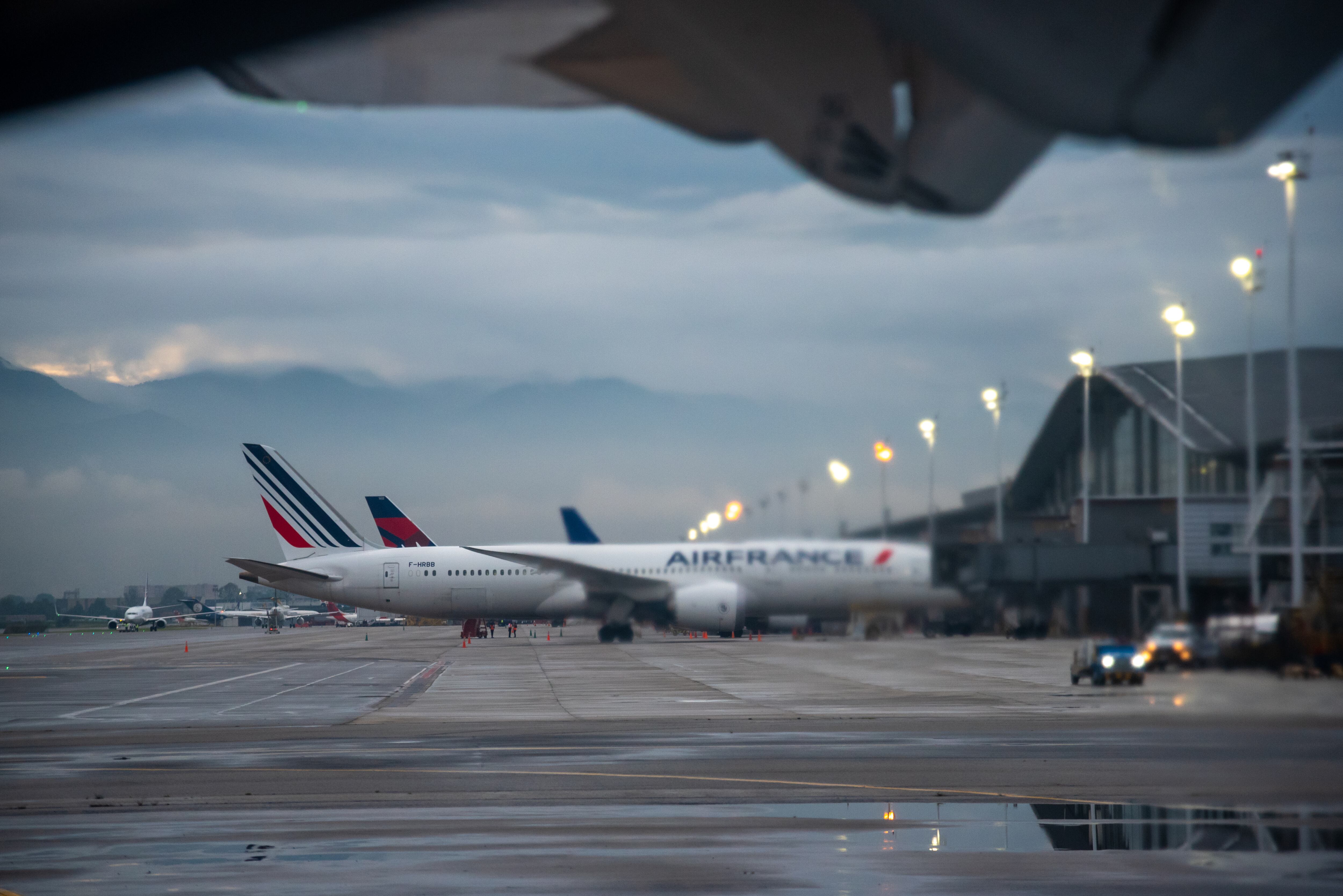 Plane of the airline Air France at the El Dorado airport in the city of Bogotá, seen through the jet of gases from an airplane turbine. Bogota Colombia. November 28, 2020