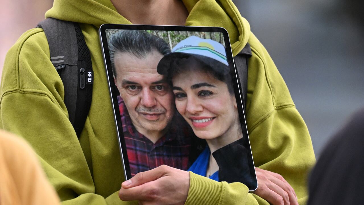 (FILES) A demonstrator holds a picture of Iranian-German Jamshid Sharmahd (L), who has been sentenced to death in Iran, with his daughter Gazelle Sharmahd during a demonstration for his release in front of the German Foreign Ministry in Berlin on July 31, 2023. The daughter of a German citizen of Iranian descent who was sentenced to death by Tehran pleaded August 22, 2023 for the United States and Germany to act urgently to save him. (Photo by INA FASSBENDER / AFP)