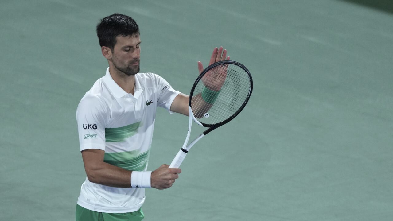 Serbia's Novak Djokovic reacts after he lost a point against Czech Republic's Jiri Vesely during a quarterfinal match of the Dubai Duty Free Tennis Championship in Dubai, United Arab Emirates, Thursday, Feb. 24, 2022. (AP/Ebrahim Noroozi)