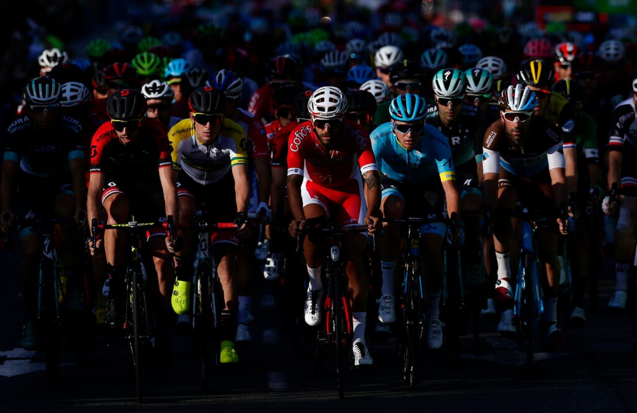 FILE - In this Sept. 16, 2018 file photo, cyclists pedal during the final leg of the Spanish Vuelta cycling race in Madrid, Spain. The Spanish Vuelta starts Tuesday Oct. 20, 2020 amid tight health restrictions in the hopes of avoiding the coronavirus infections that have knocked some riders out of the Giro d'Italia. (AP Photo/Manu Fernandez, File)
