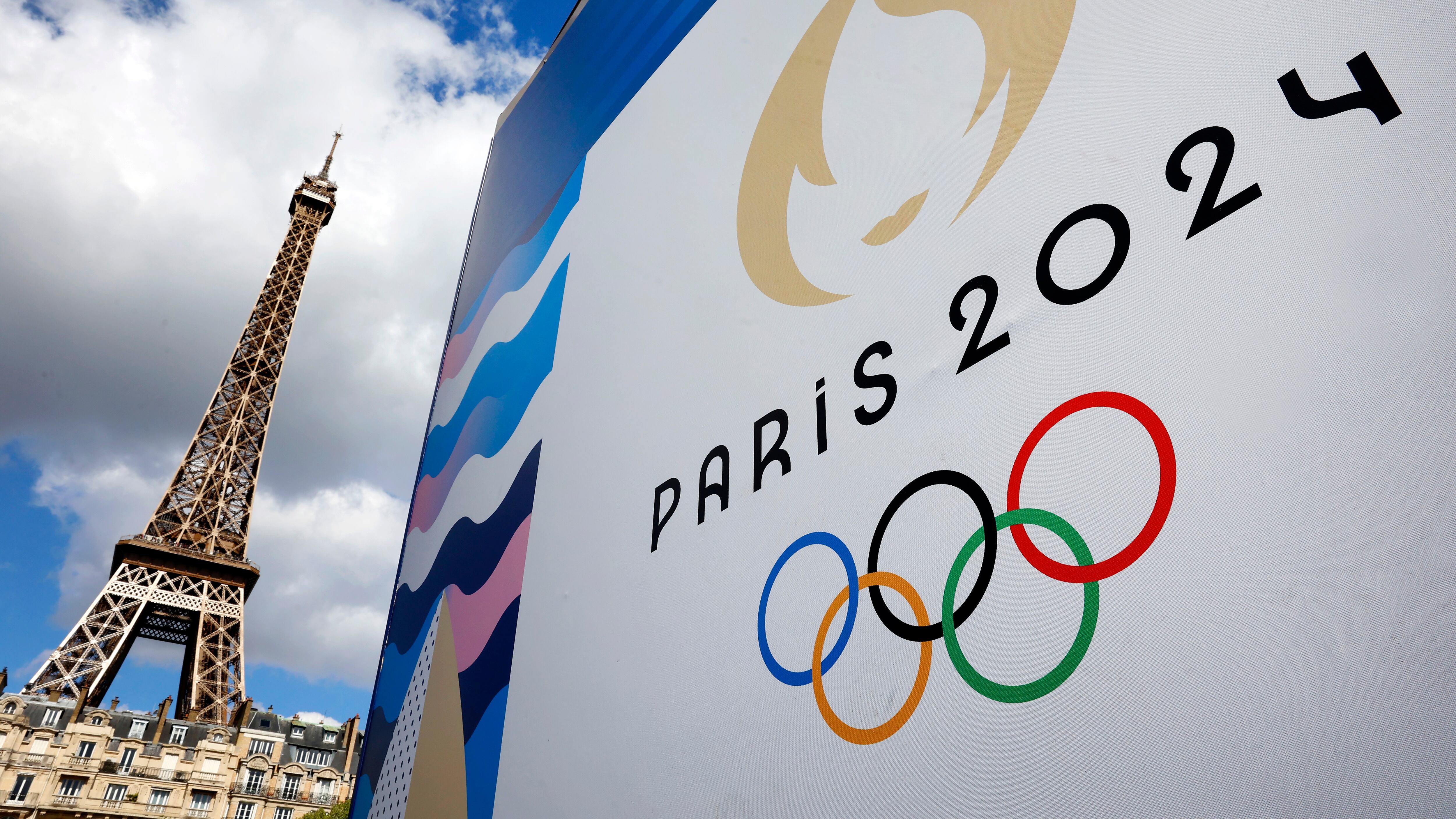 PARIS, FRANCE - APRIL 21: The Paris 2024 logo, representing the Olympic Games is displayed near the Eiffel Tower three months prior to the start of the Paris 2024 Olympic and Paralympic games on April 21, 2024 in Paris, France. The city is gearing up to host the XXXIII Olympic Summer Games, from 26 July to 11 August. (Photo by Chesnot/Getty Images)