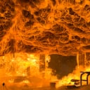 Fire and Intense Flames Burns Home to the Ground. Flashpoint reached in large destructive fire burns a home to the ground. Image looking toward what was once an attached garage. Fire is reaching flashpoint and a raw force of nature. Converted from 14-bit RAW file. sRGB color space.