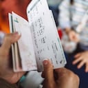 Cropped shot of a female traveller checking her boarding pass & passport at the boarding gate in the airport.