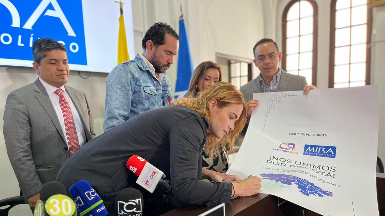 La representante Carolina Arbeláez y el concejal Rolando González firman el convenio por parte de Cambio Radical. Junto a ellos el senador de MIRA Carlos Guevara