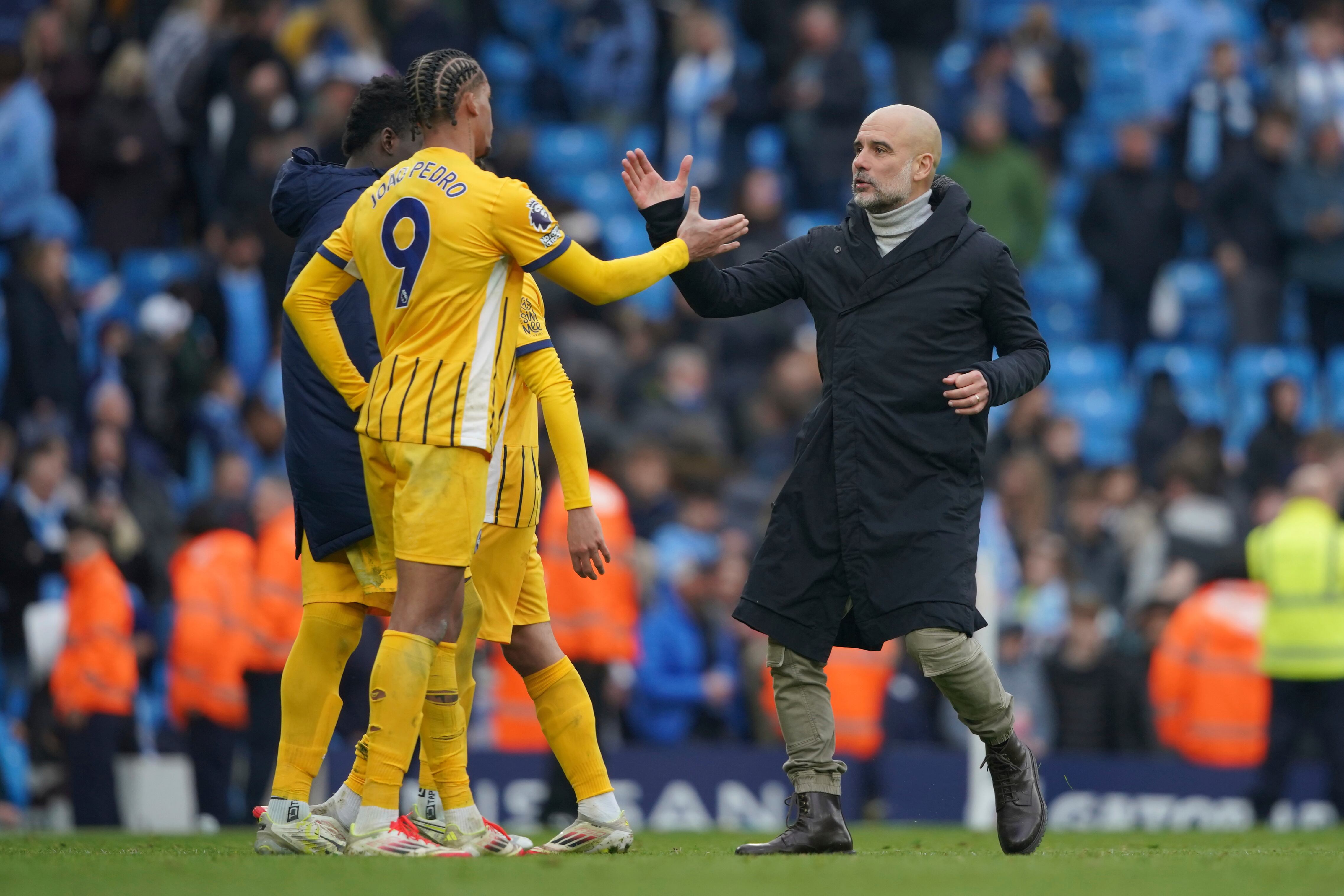 Manchester City's head coach Pep Guardiola, right, greets Brighton's Joao Pedro at the end of the English Premier League soccer match between Manchester City and Brighton and Hove Albion at Etihad stadium in Manchester, England, Saturday, March 15, 2025. (AP Photo/Ian Hodgson)