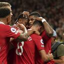 Manchester United's Marcus Rashford celebrates with his teammates after scoring his side's second goal during the English Premier League soccer match between Manchester United and Liverpool at Old Trafford stadium, in Manchester, England, Monday, Aug 22, 2022. (AP Photo/Dave Thompson)