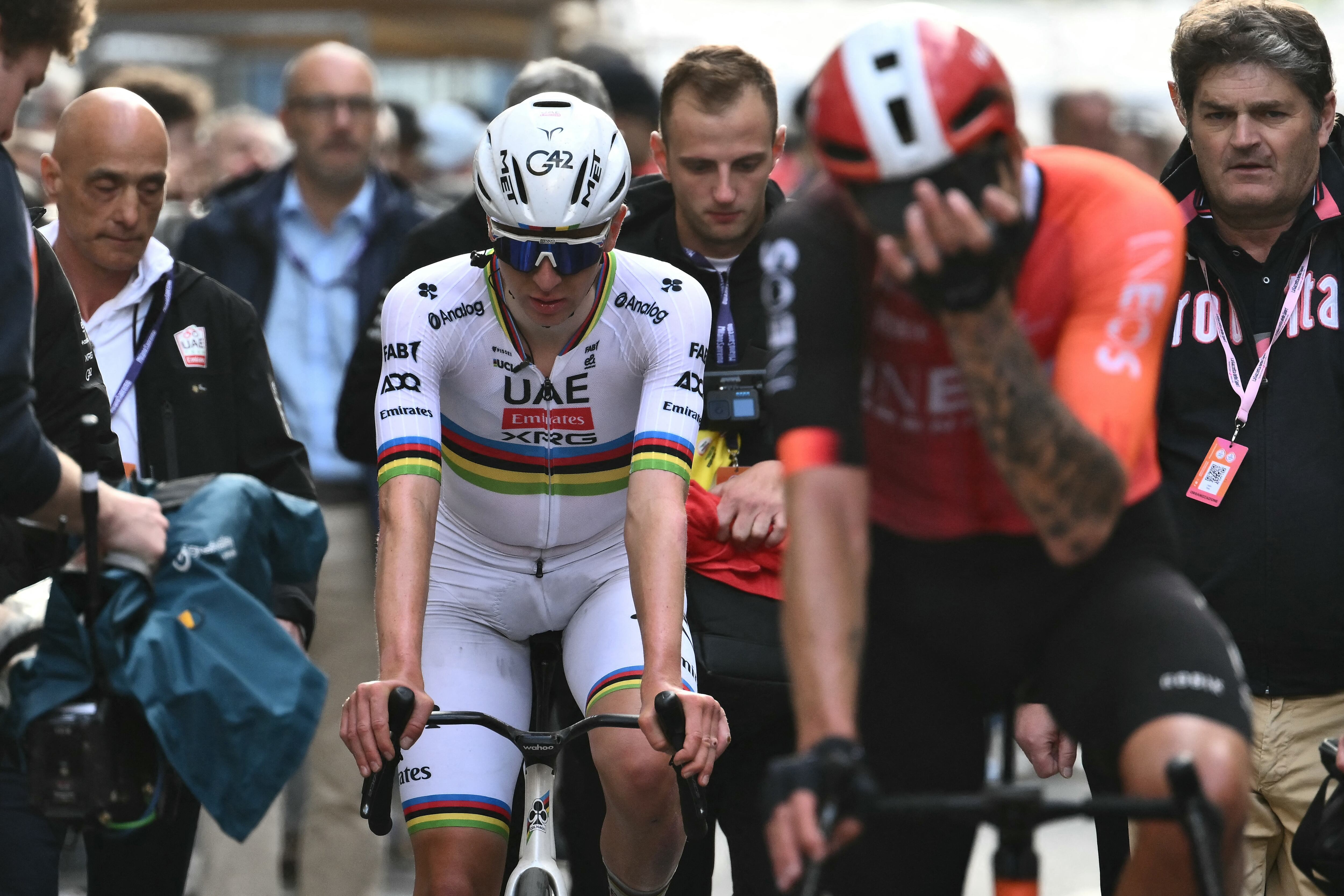 Team UAE's Slovenian rider Tadej Pogacar (L), third, and Team Ineos' Italian rider Filippo Ganna (R), second, are pictured after the Milan - Sanremo one-day classic cycling race, on March 22, 2025. Dutch Mathieu Van Der Poel of team Alpecin-Deceuninck won the race ahead of Team Ineos' Italian rider Filippo Ganna and Team UAE's Slovenian rider Tadej Pogacar, third. (Photo by Marco BERTORELLO / AFP)