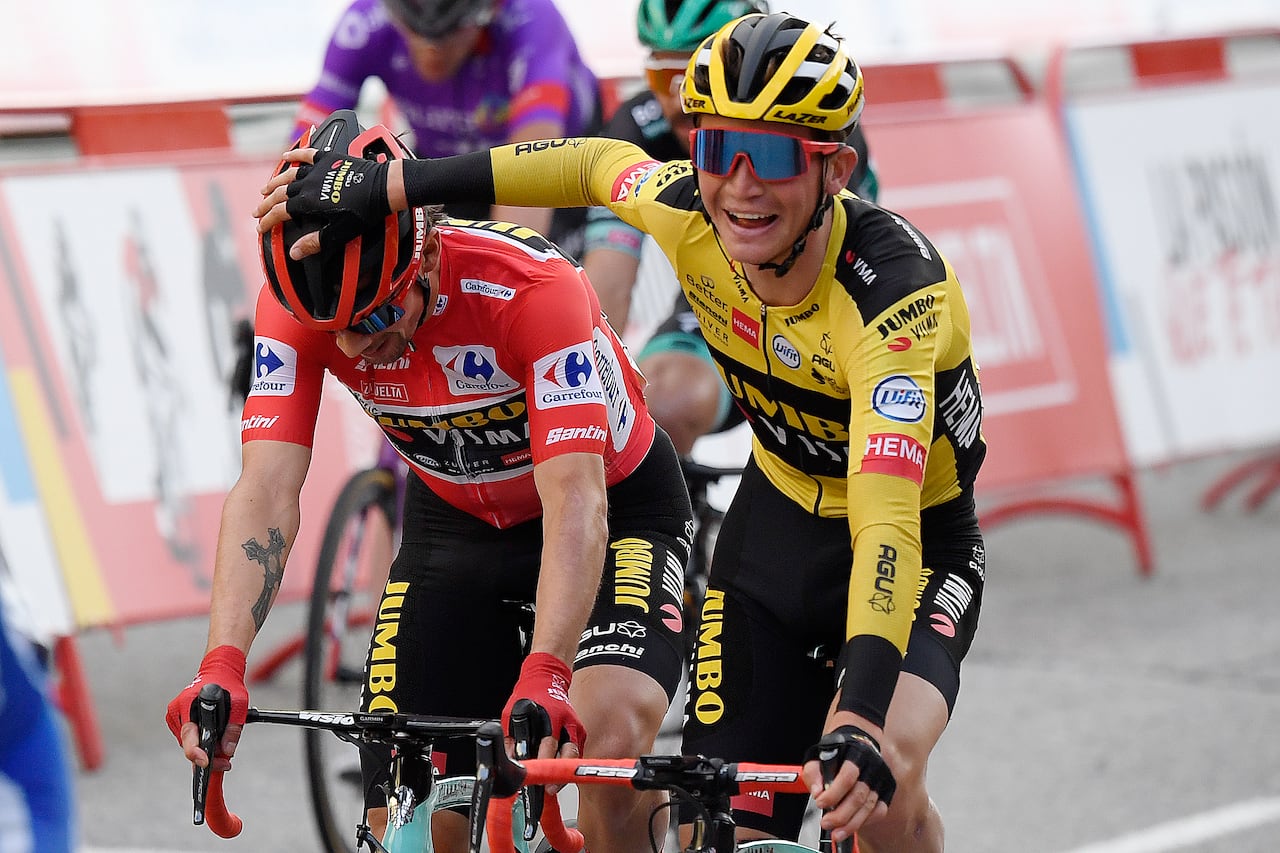 Team Jumbo's Slovenian rider Primoz Roglic (L) is congratluated for winning the 2020 La Vuelta at the end of the 18th and final stage of the 2020 La Vuelta cycling tour of Spain, a 124,2-km race from the Zarzuela racecourse to central Madrid, on November 8, 2020. (Photo by OSCAR DEL POZO / AFP)
