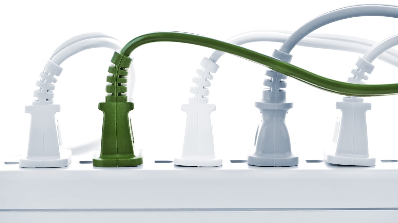 Many plugs plugged into electric power bar