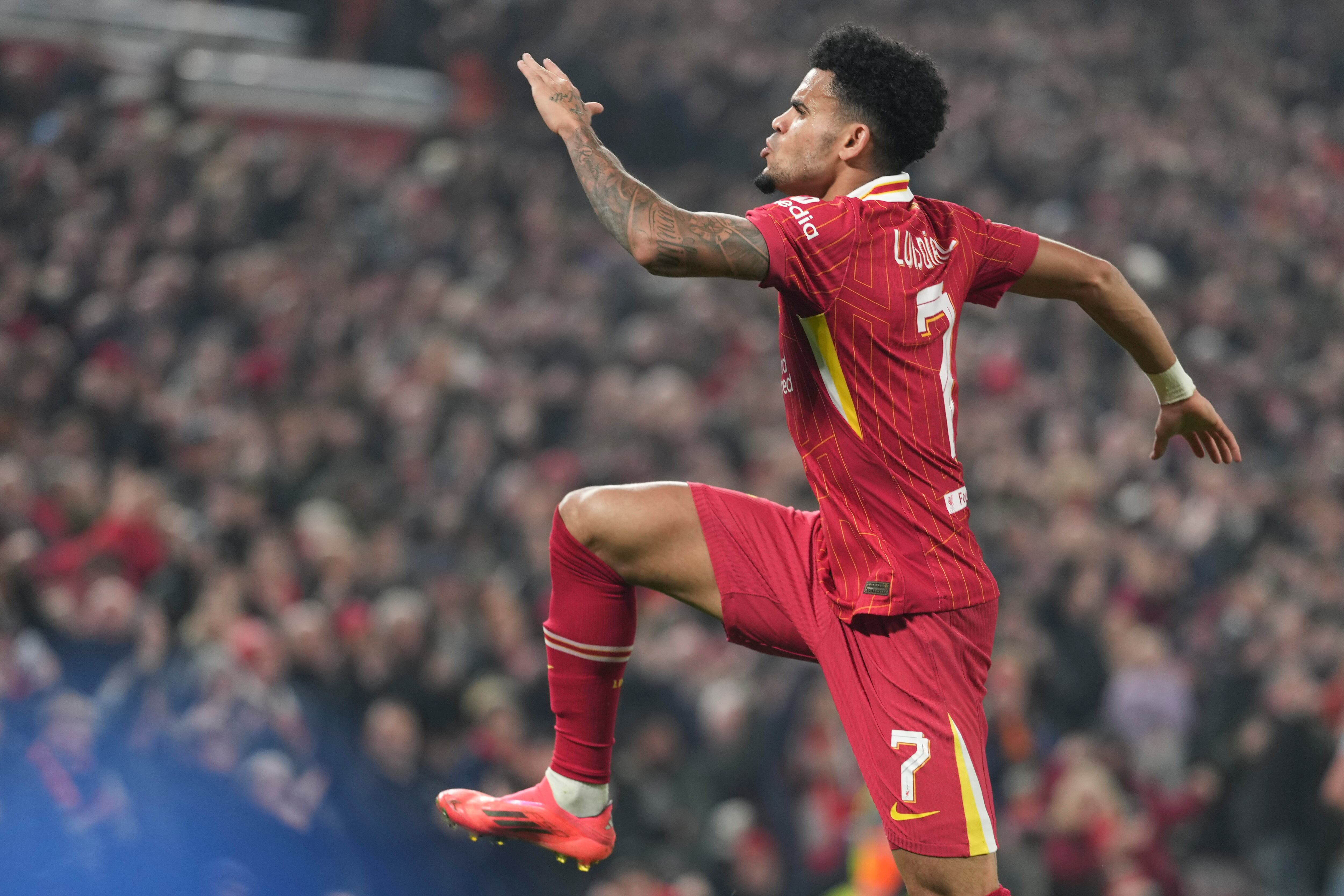 Liverpool's Luis Diaz celebrates after scoring his side's opening goal during the Champions League opening phase soccer match between Liverpool and Bayer Leverkusen at Anfield in Liverpool, England, Tuesday, Nov. 5, 2024. (AP Photo/Jon Super)