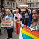 Transgender woman holding a sign during a demonstration in the street