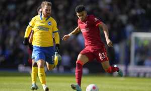Liverpool's Luis Diaz, right, challenges for the ball with Brighton's Alexis Mac Allister during the English Premier League soccer match between Brighton and Hove Albion and Liverpool at the Amex stadium in Brighton, England, Saturday, March 12, 2022. (AP Photo/Kirsty Wigglesworth)